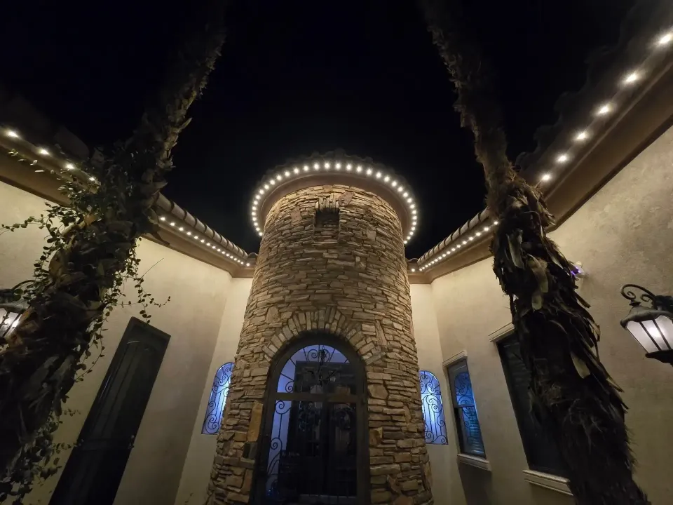Stone tower entryway with warm outdoor lighting at night