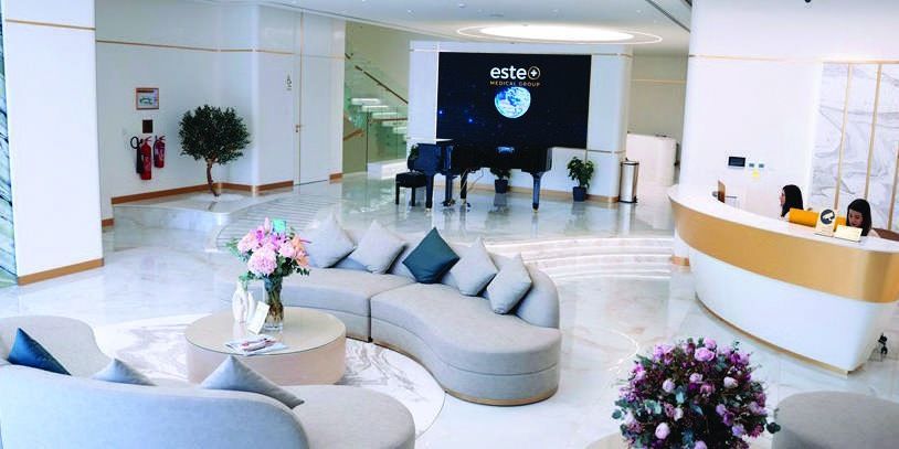 Este Medical Group reception with curved white desk, designed by Levantine Healthcare