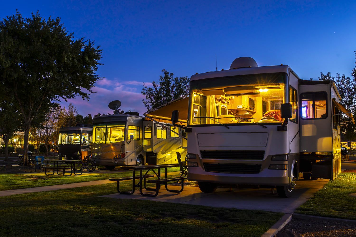 RV is Parked in a Campground at Night RV is Parked in a Campground at Night