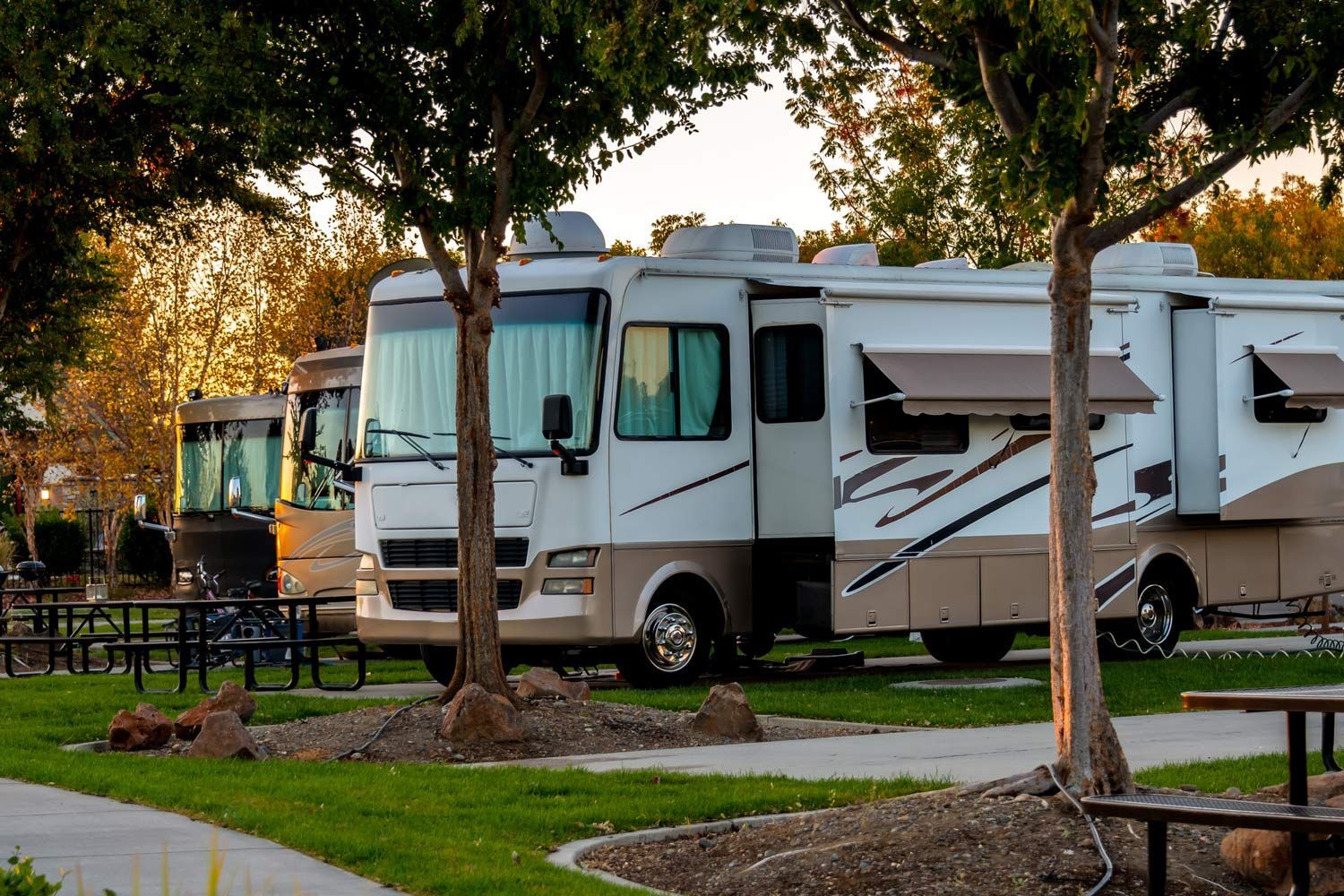 Row of RV are Parked in a Park Row of RV are Parked in a Park