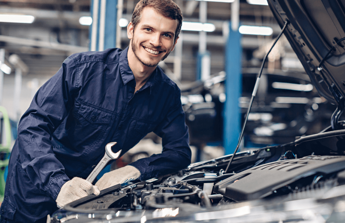 a mobile mechanic looking under the hood
