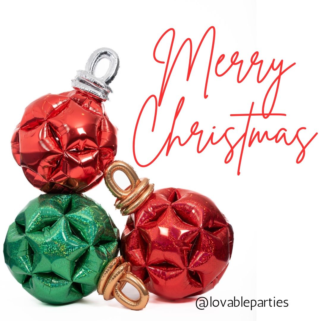Red and green Christmas ornaments, stacked with