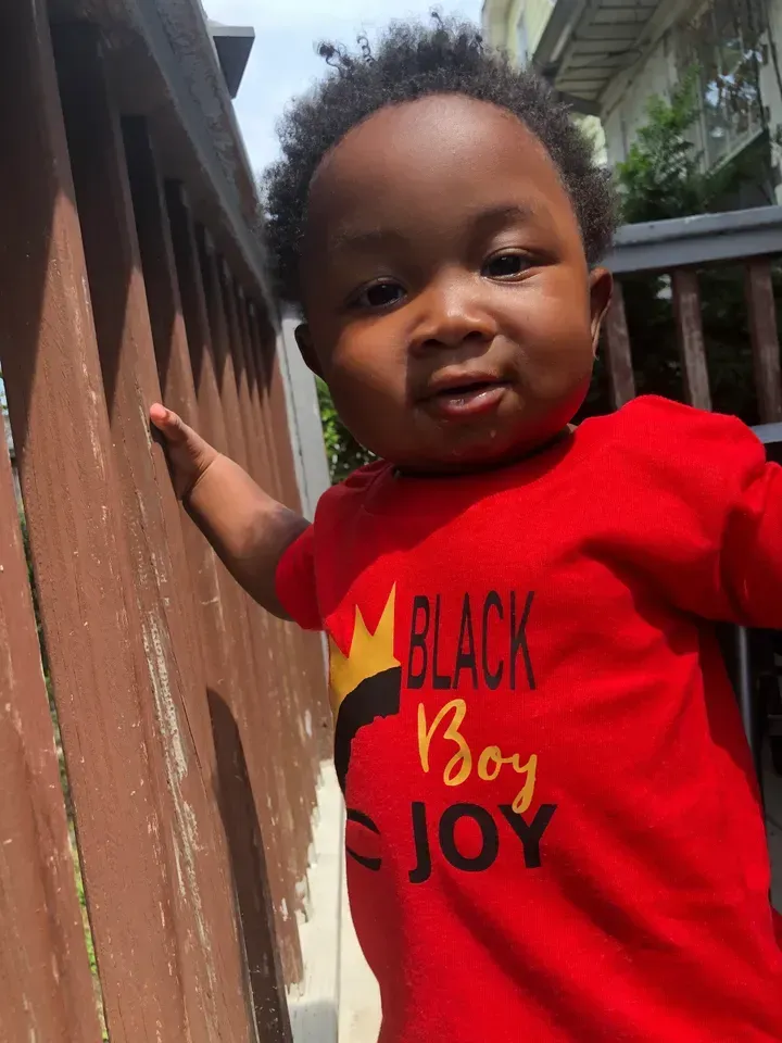 Young child in a red shirt that says