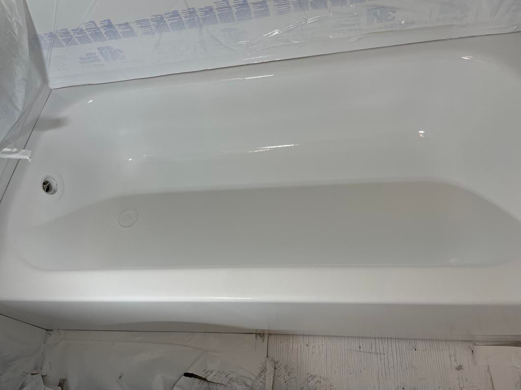 White bathtub with a few soap stains in a bathroom under renovation