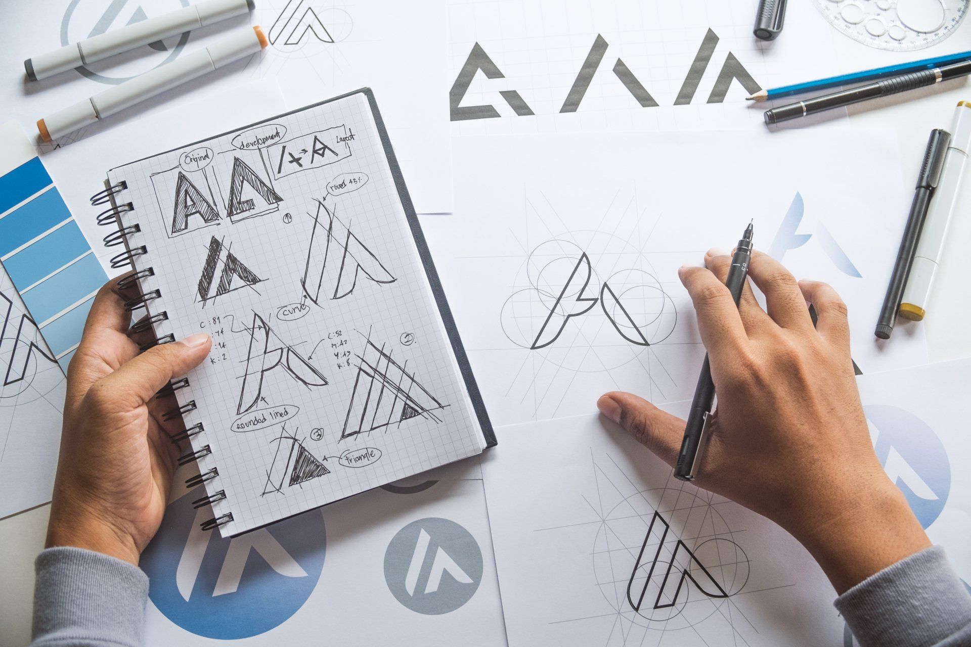 Graphic designer drawing sketch design creative Ideas draft Logo product trademark label brand artwork.