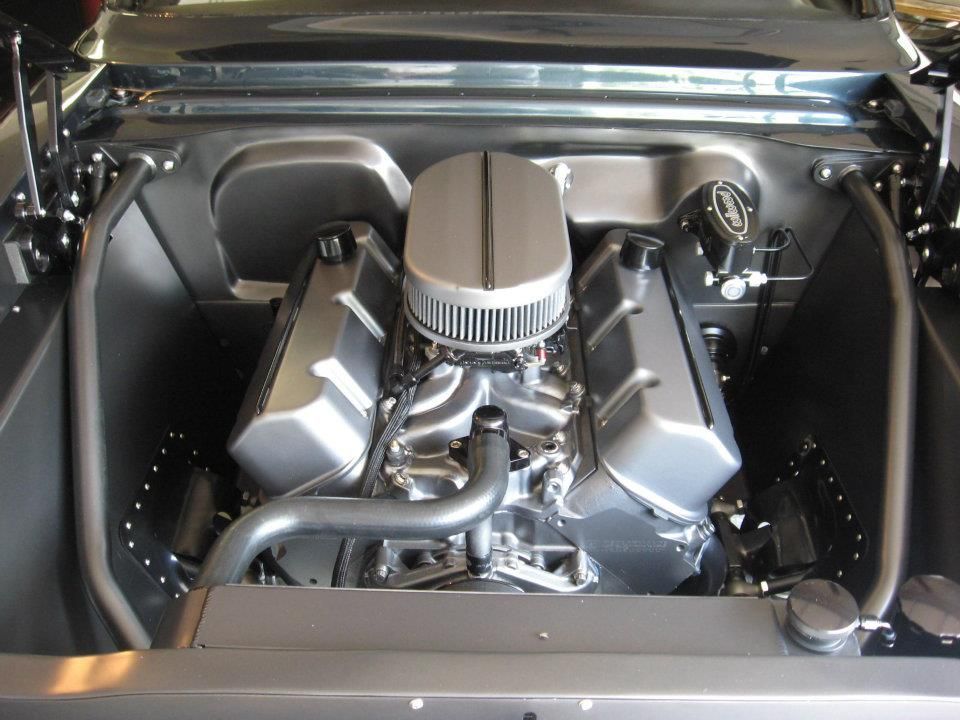 Gray engine in a black car engine bay.