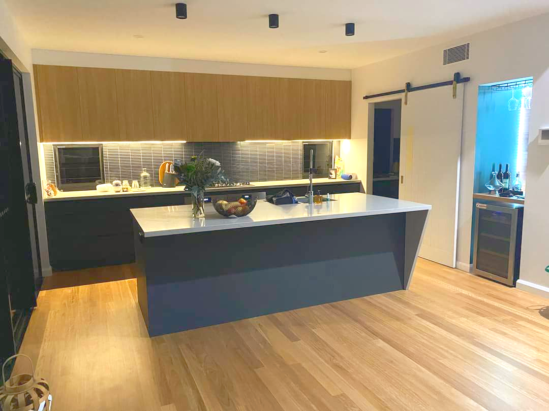A Kitchen With White Cabinets and a Clock on the Wall — Crispin Cabinetmakers in South Grafton, NSW
