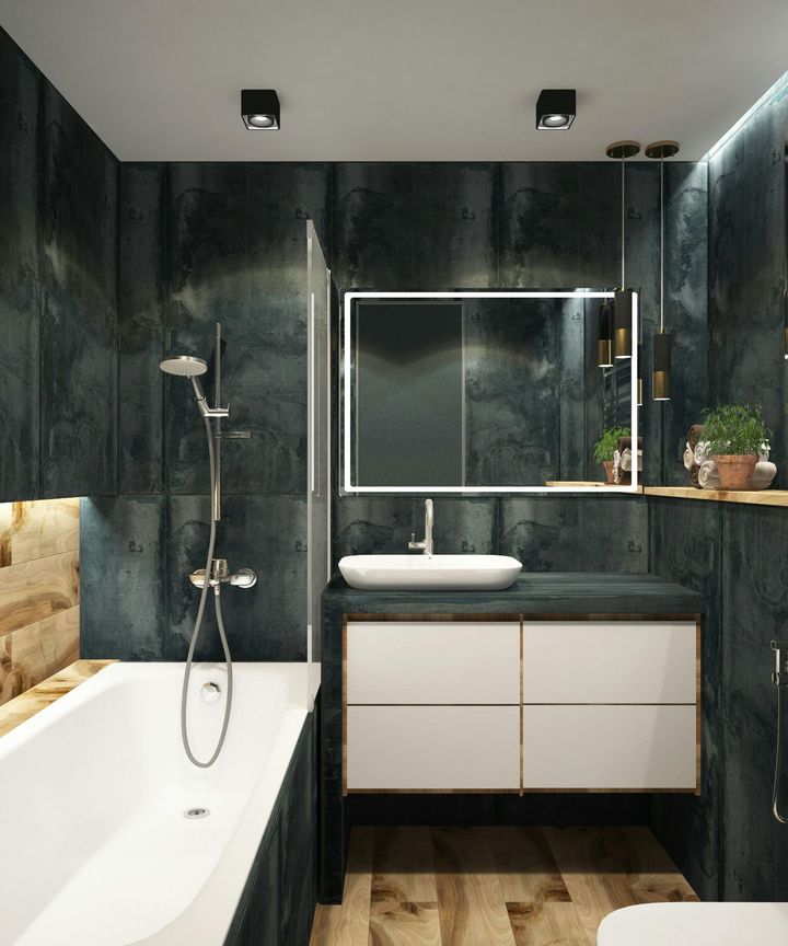 Modern bathroom with a bathtub, vanity, and dark teal-colored walls.