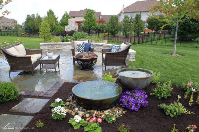 There is a fountain in the middle of the garden.