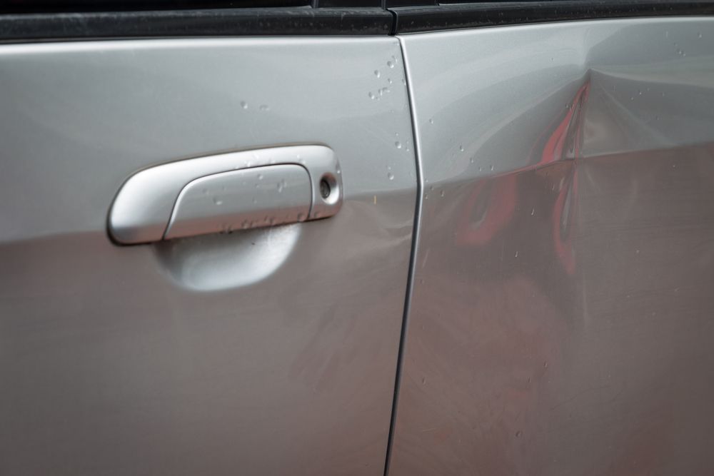 Silver Car Door Handle with A Small Dent — Westside Panels & Towing in Prospect Vale, TAS