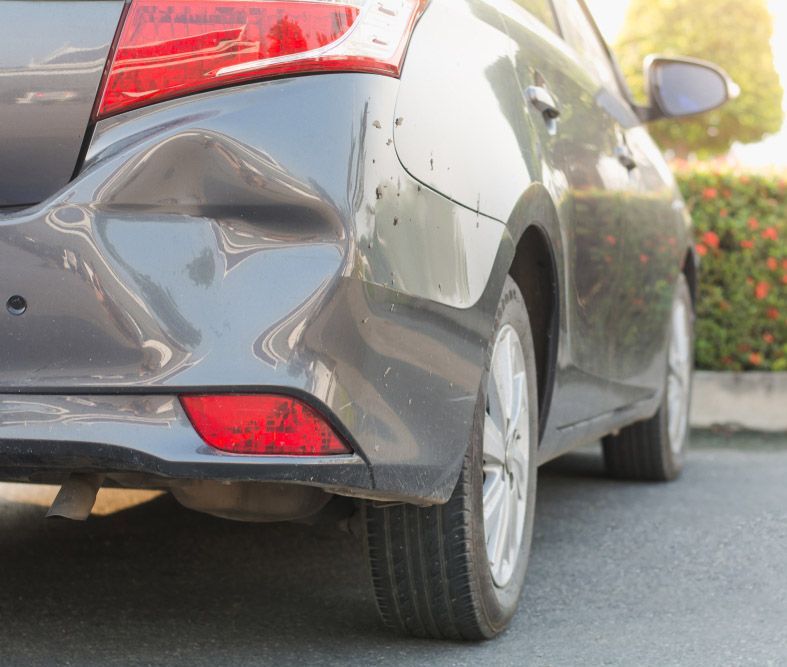 A Smashed Vehicle With a Dent in the Rear Bumper — Westside Panels & Towing in Prospect Vale, TAS