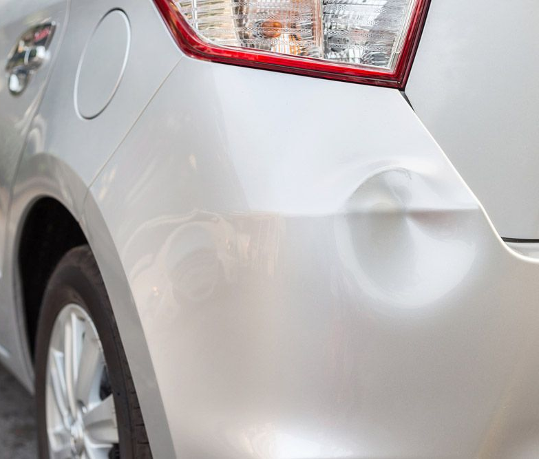 A Small Car with a Dent in the Rear Bumper — Westside Panels & Towing in Prospect Vale, TAS