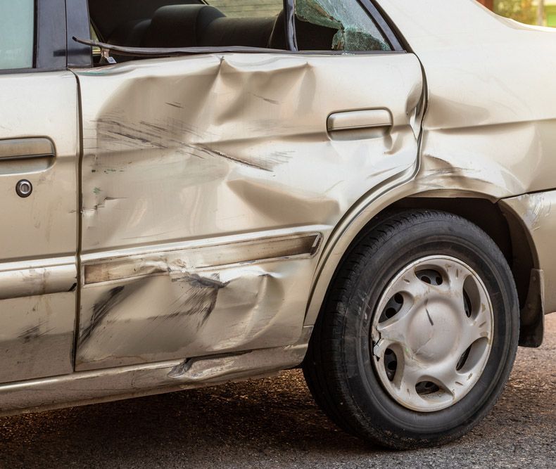 A Gold Sedan With a Dent in the Rear Side Door — Westside Panels & Towing in Prospect Vale, TAS