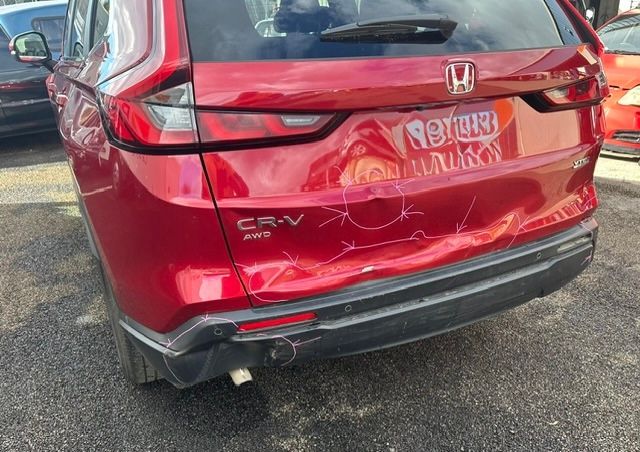 Rear view of a red Honda CR-V with visible rear-end damage and a dented tailgate— Westside Panels & Towing in Prospect Vale, TAS