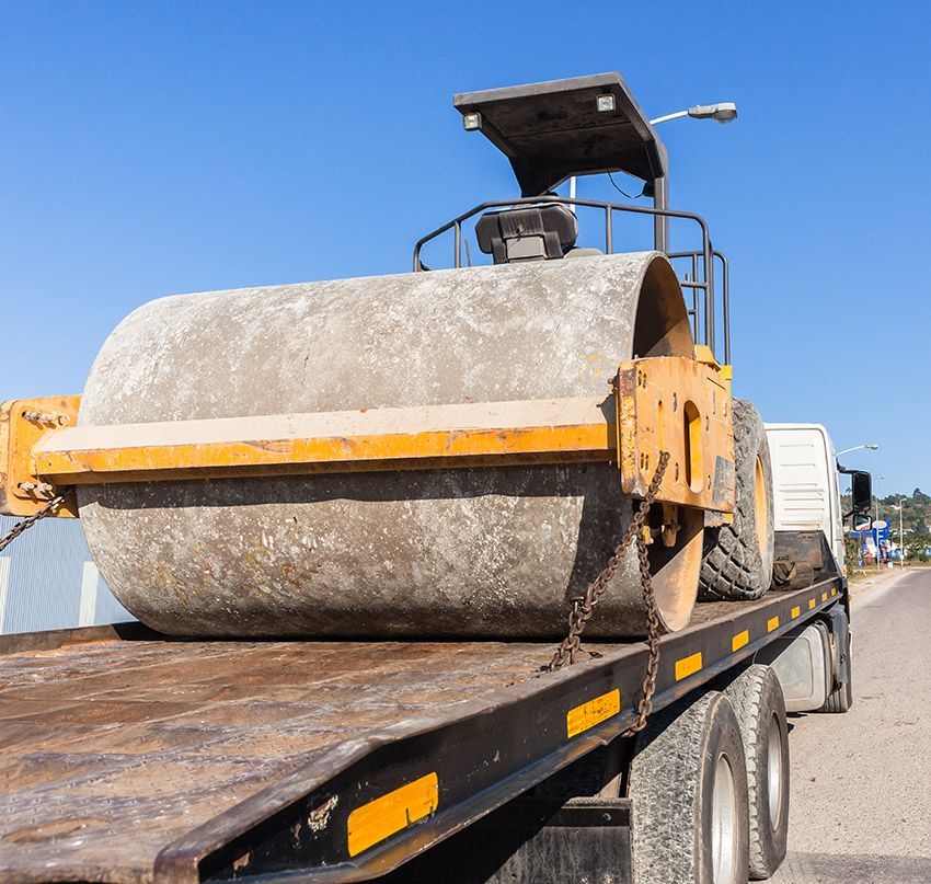 A Large Rolling Machine Being Towed on a Truck — Westside Panels & Towing in Prospect Vale, TAS