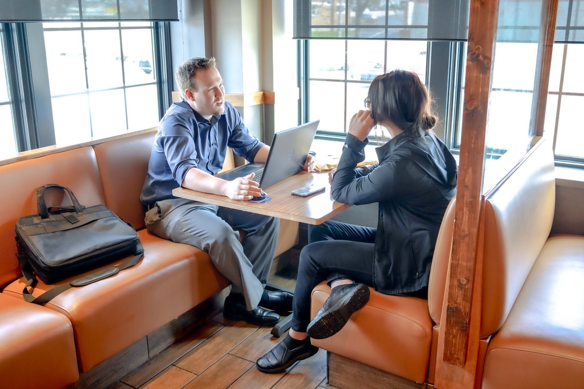 IHOP manager and employee meet in a restaurant booth