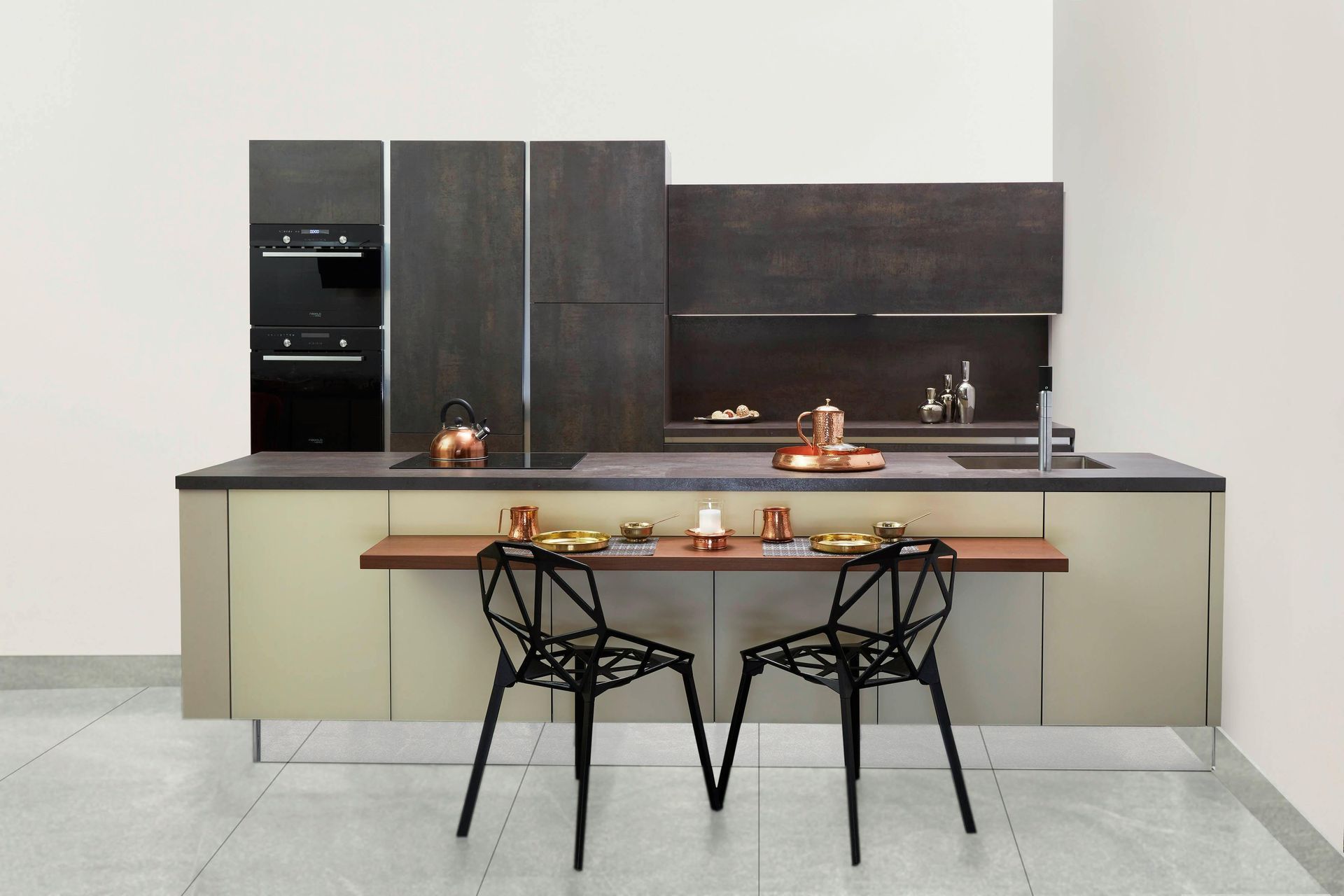 A newly added kitchen island with a wood dining counter, black geometric chairs, wood cabinets.