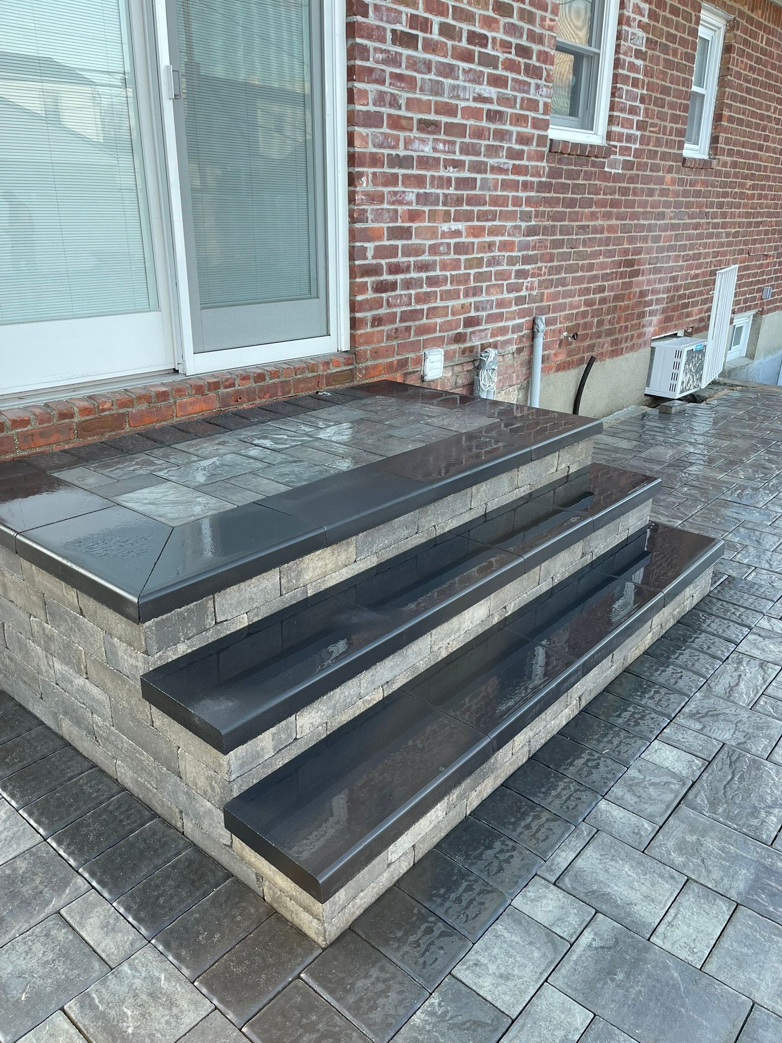A set of stairs leading up to a brick building.