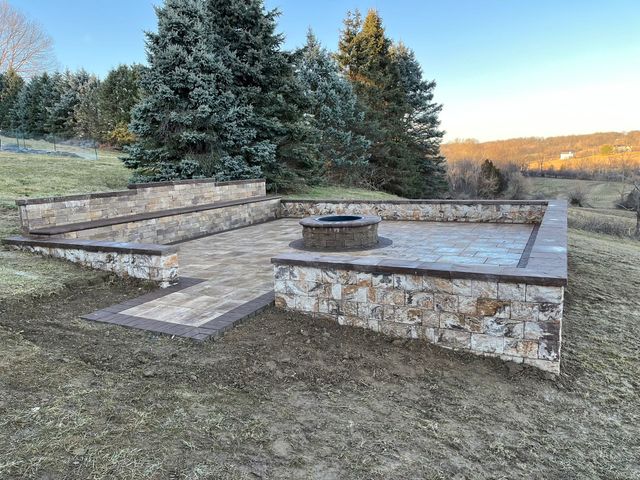 There is a fire pit in the middle of the patio.