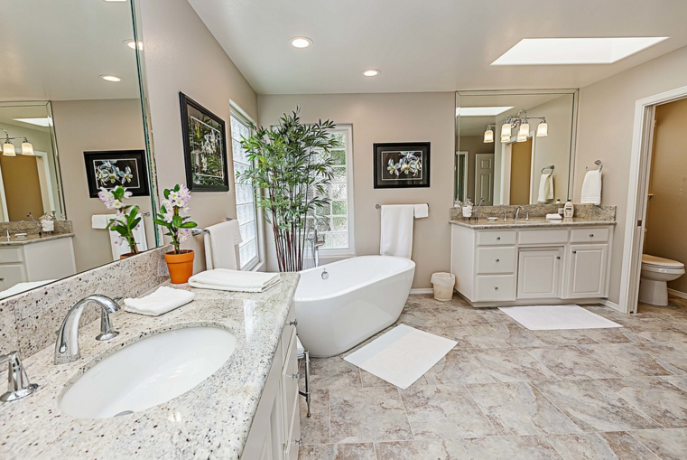 Luxurious master bathroom with dual sinks, soaking tub, and neutral color scheme.