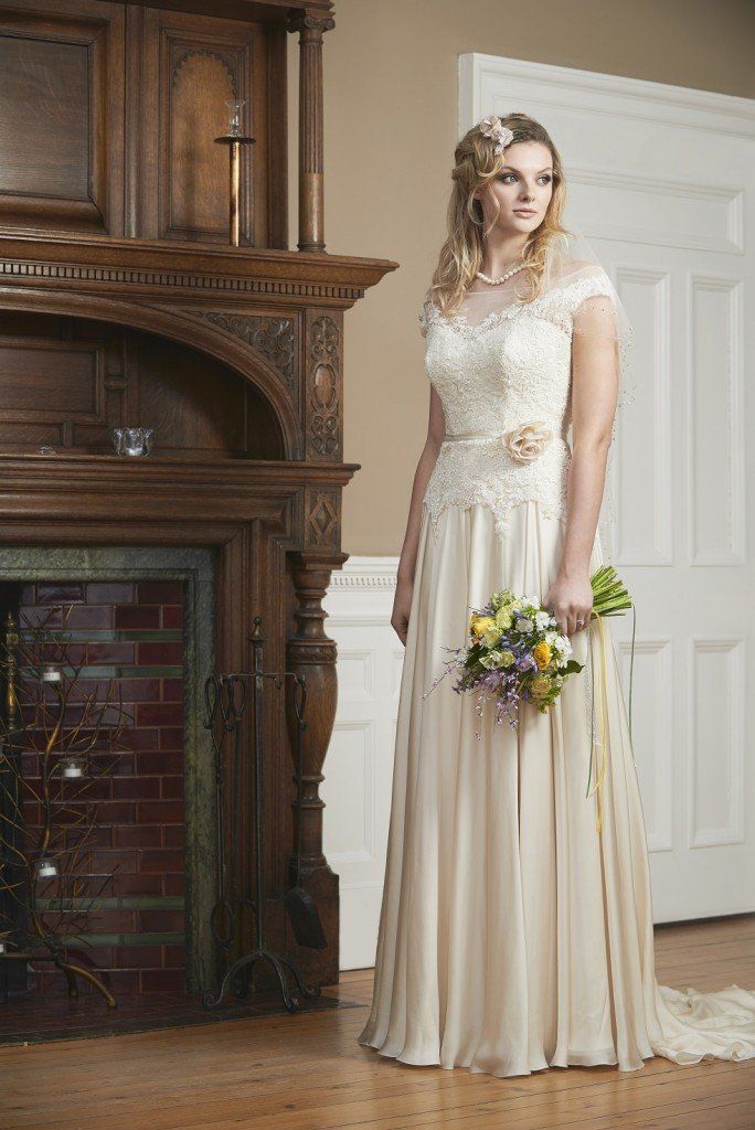 A woman in a wedding dress is holding a bouquet of flowers