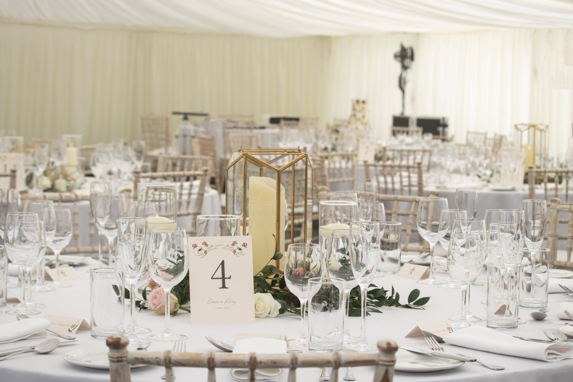 A table set for a wedding reception with the number 1 on it