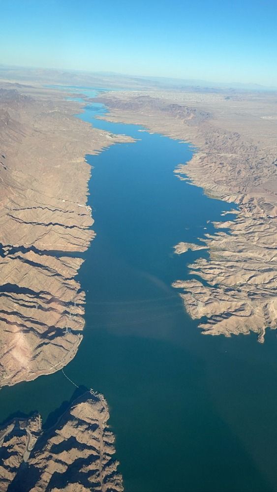 An aerial view of a large body of water surrounded by mountains.