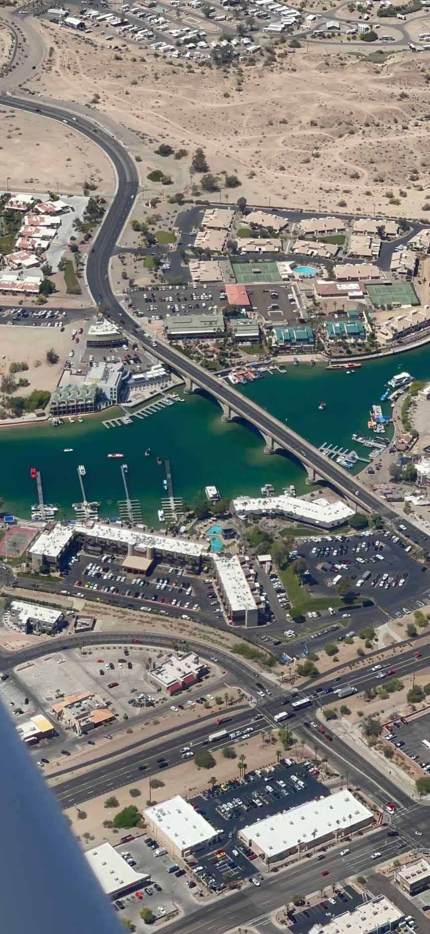 An aerial view of a city with a bridge over a body of water.