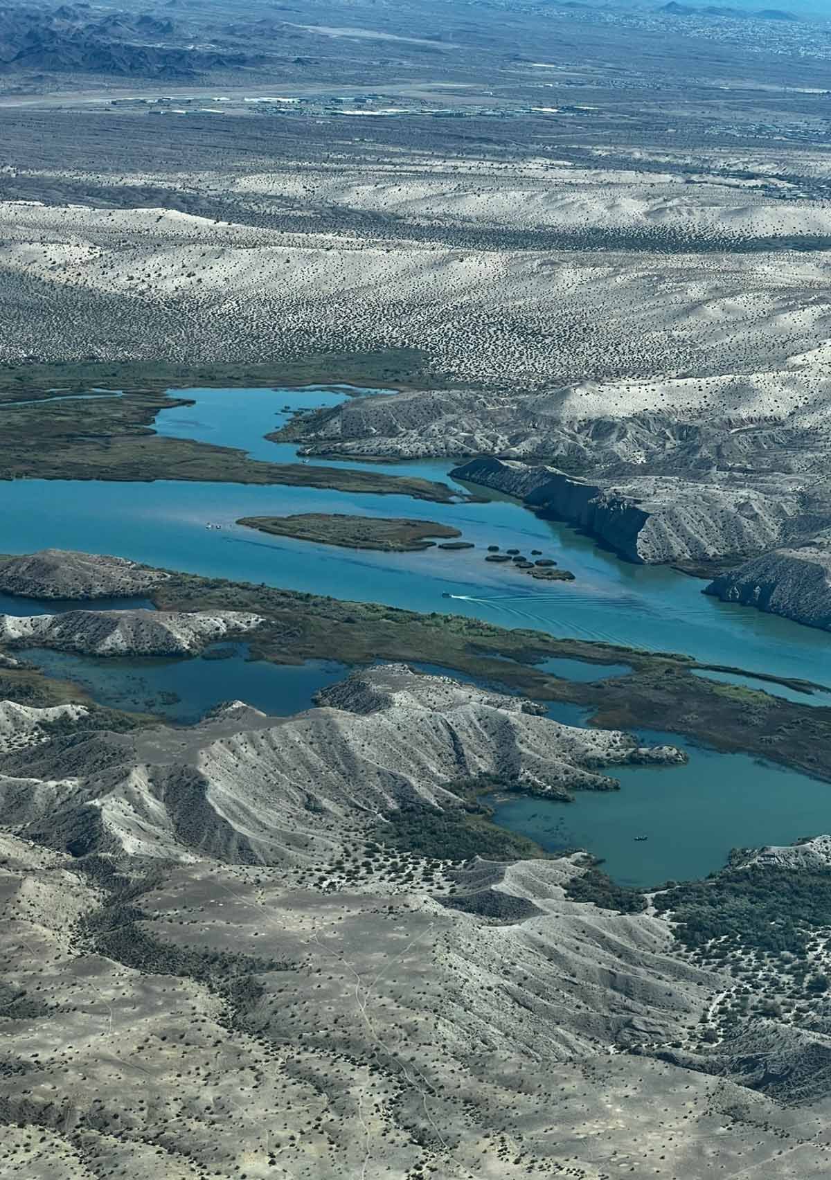 An aerial view of a large body of water surrounded by mountains.