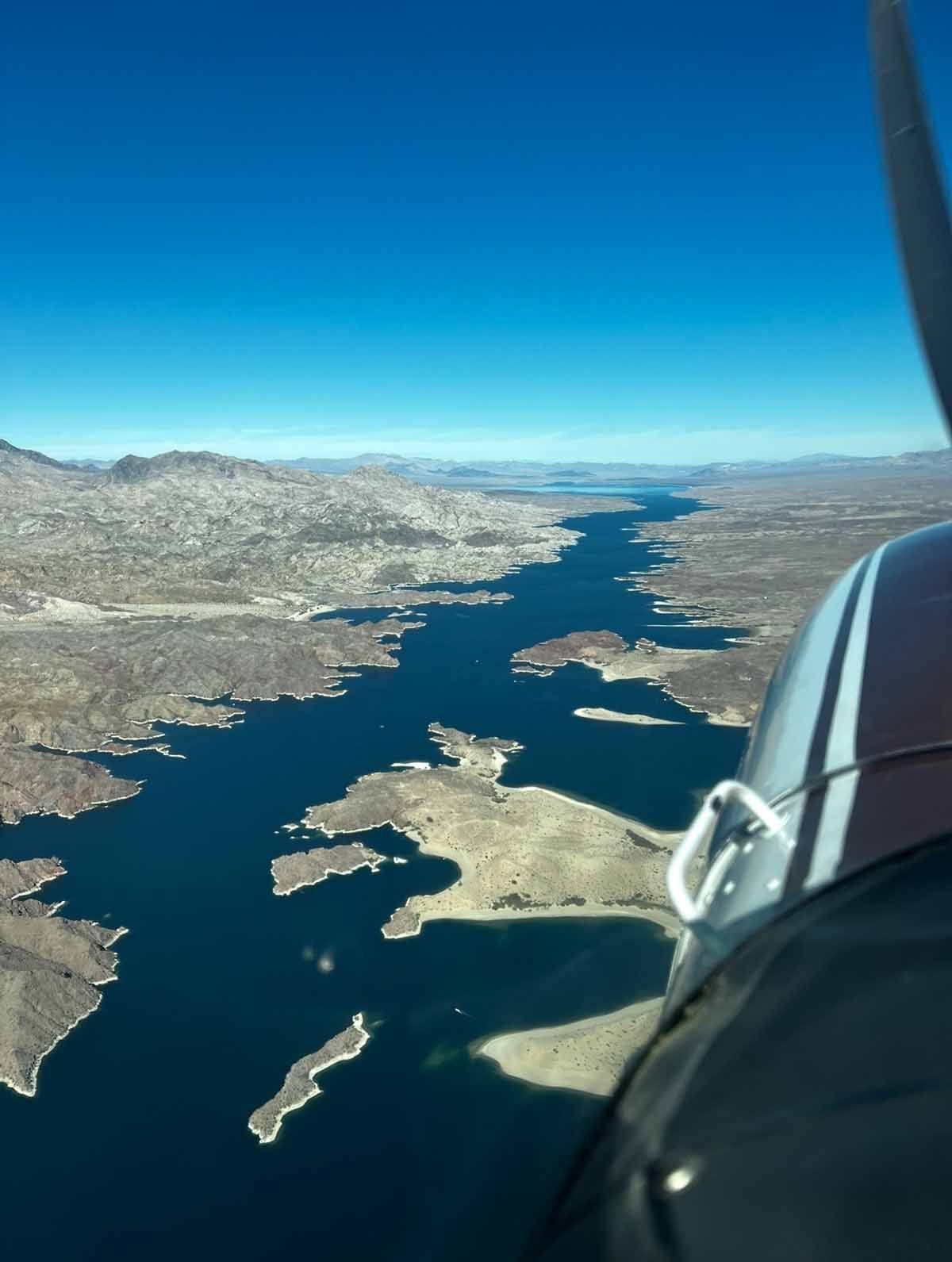 An aerial view of a body of water with mountains in the background