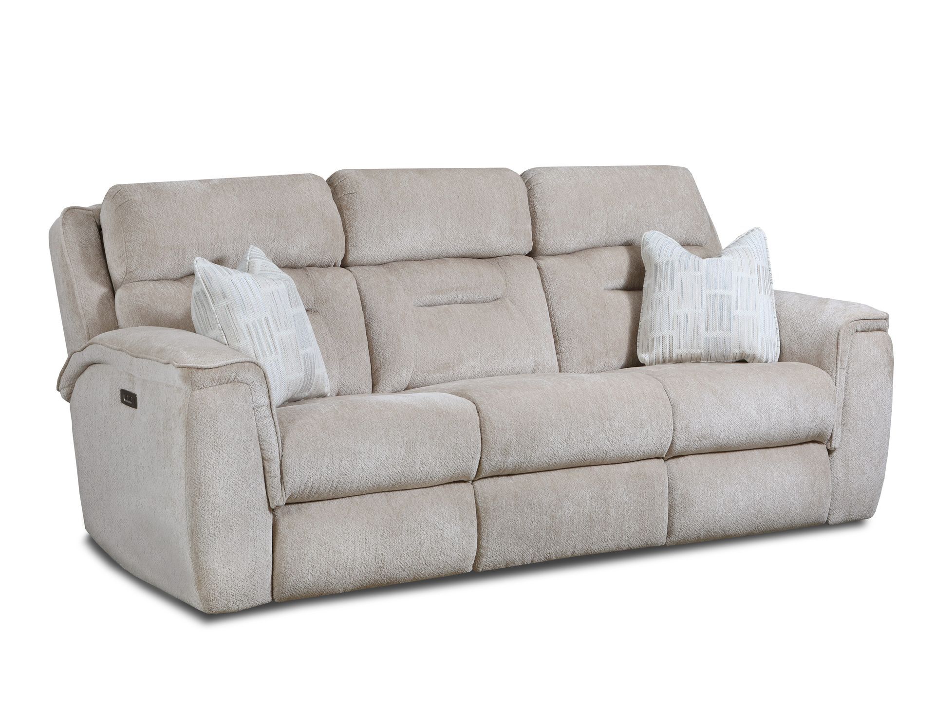 A beige, three-seat reclining sofa featuring plush, textured fabric and two decorative white throw pillows.