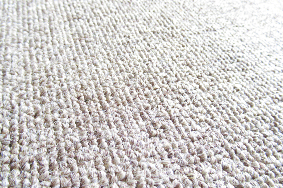 A close up of a white carpet with a pattern on it.