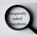 Magnifying glass over the words “Frequently asked Questions” on a white background