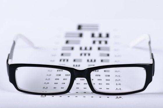 A pair of glasses sitting on top of a piece of paper