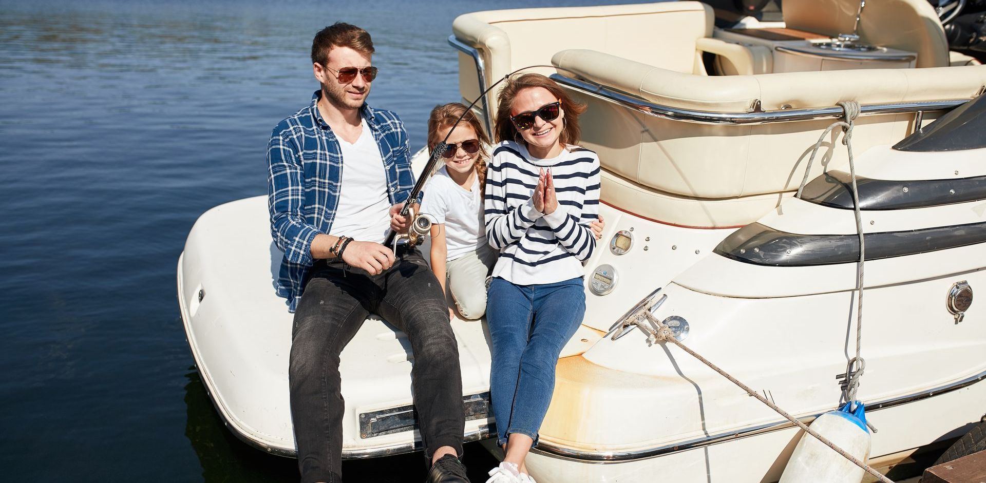 A group of people are sitting on the back of a boat.