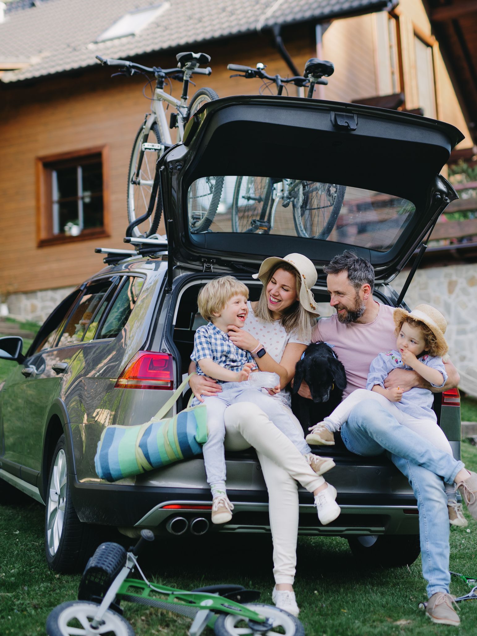 A family is sitting in the back of a car.