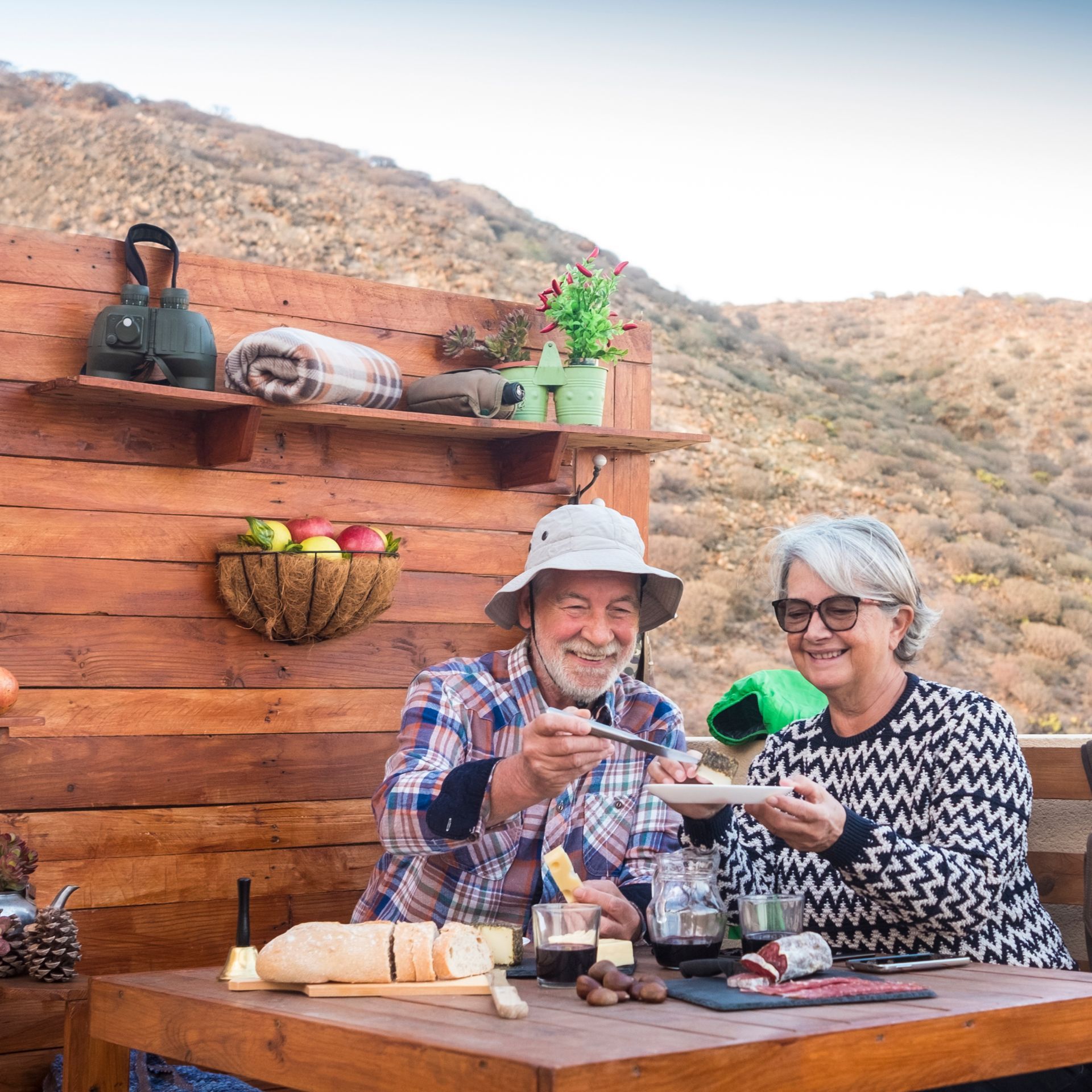 A man and a woman are sitting at a table eating food.