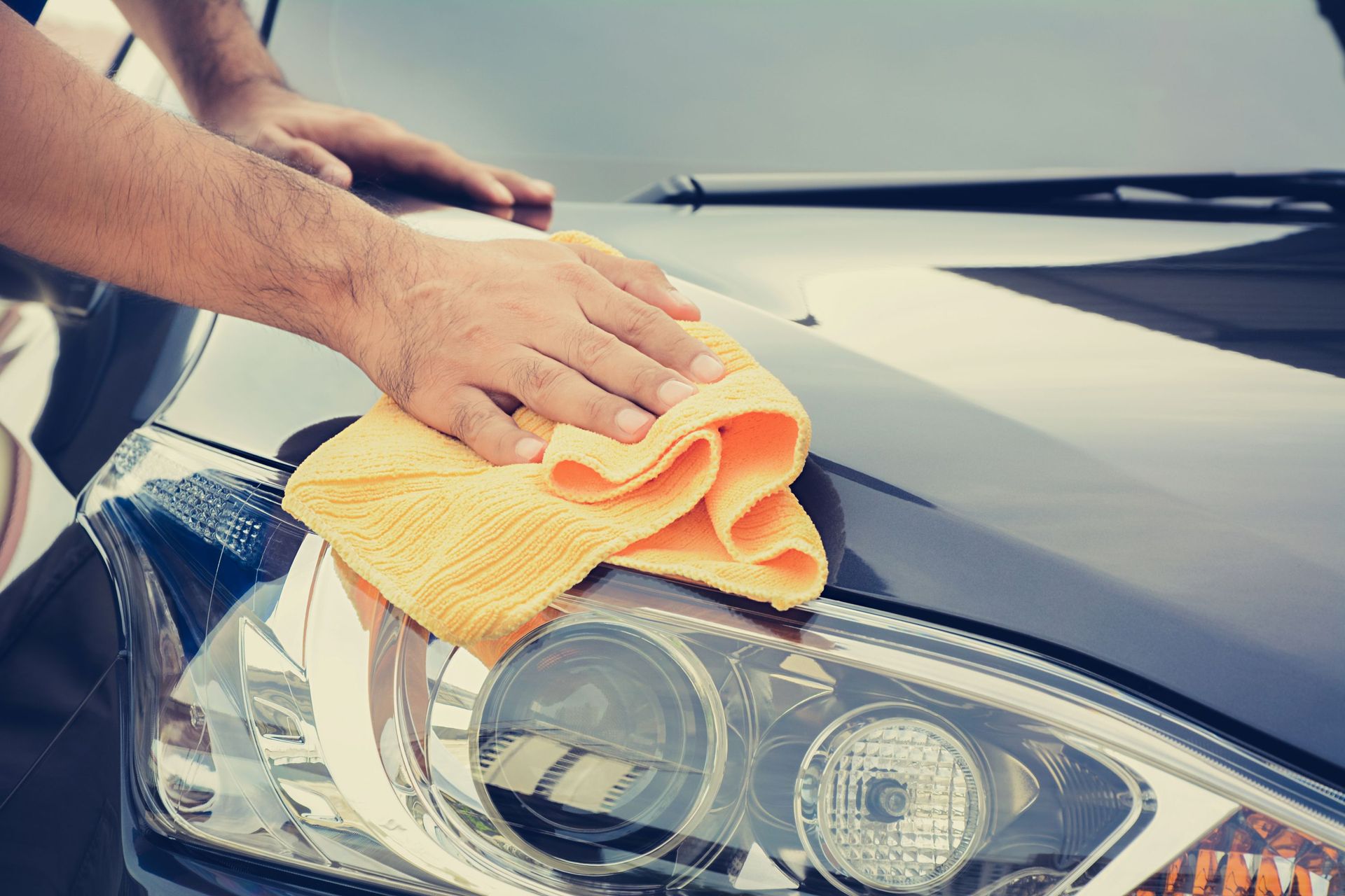 man cleaning car microfiber cloth detailing