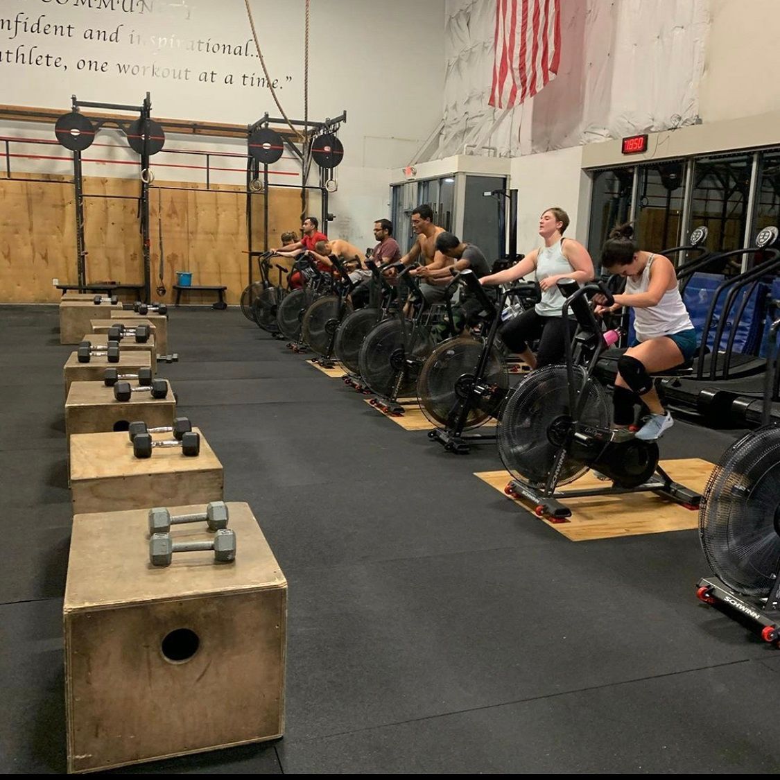 A group of people are riding exercise bikes in a gym