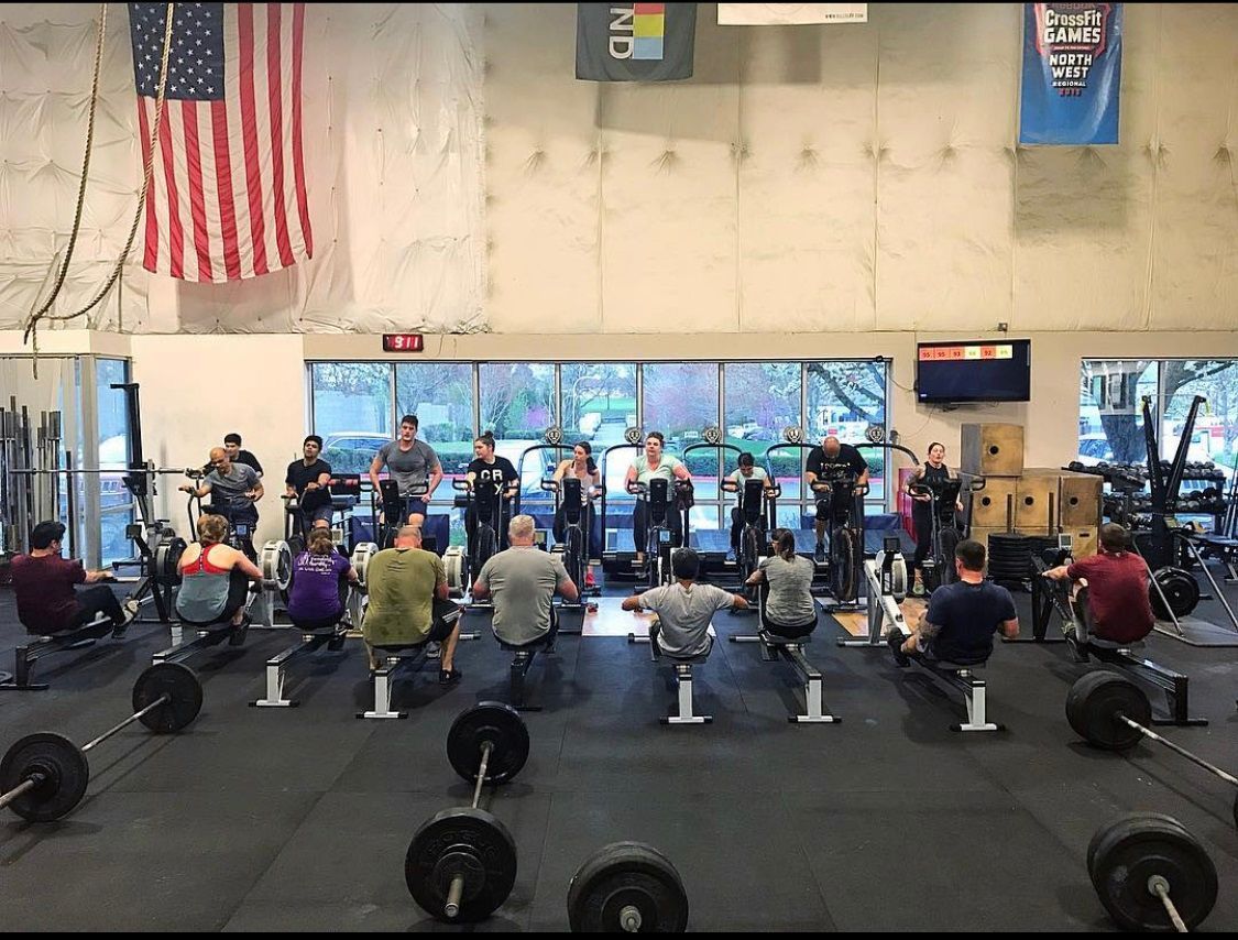 A group of people are doing exercises in a gym.