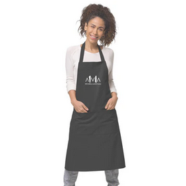 A person smiling and wearing a black apron with a white logo on the chest, standing against a white background.