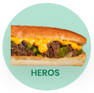 Philly cheesesteak sandwich with melted yellow cheese and green peppers.