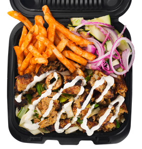 Chicken shawarma platter with fries and salad, drizzled with white sauce, in a black container.