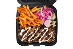 Gyro meat and fries in a black takeout container with salad and white sauce.
