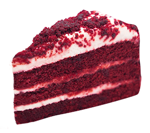 Slice of red velvet cake with white frosting and red crumbles.