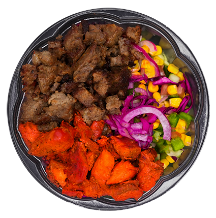 A bowl of food with chunks of meat, orange vegetables, corn, and red cabbage.
