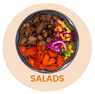 Salad bowl with various ingredients: meat, sweet potatoes, corn, onions, and greens.