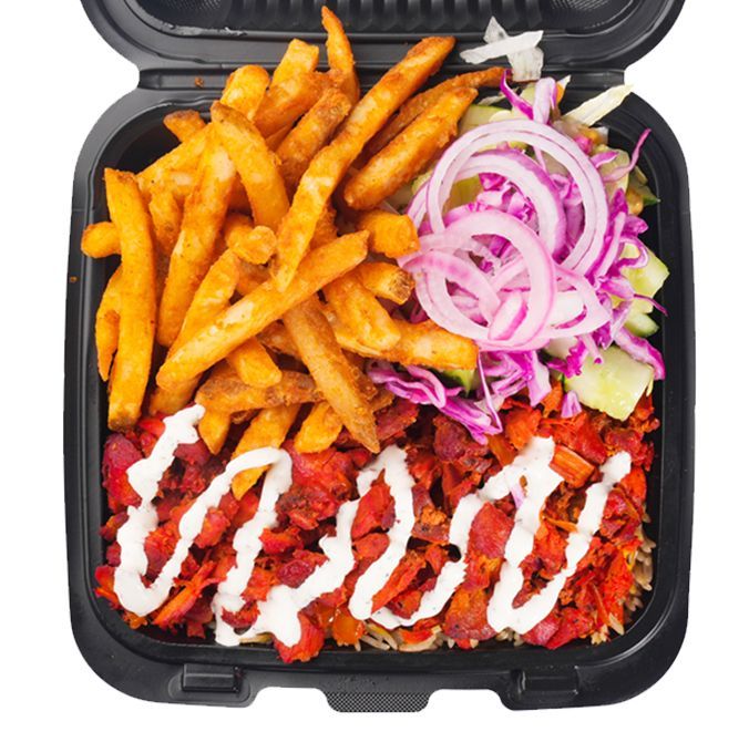 Takeout container with fries, chicken, onions, slaw, and white sauce.