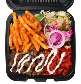 Food container with fries, meat, vegetables, and white sauce.