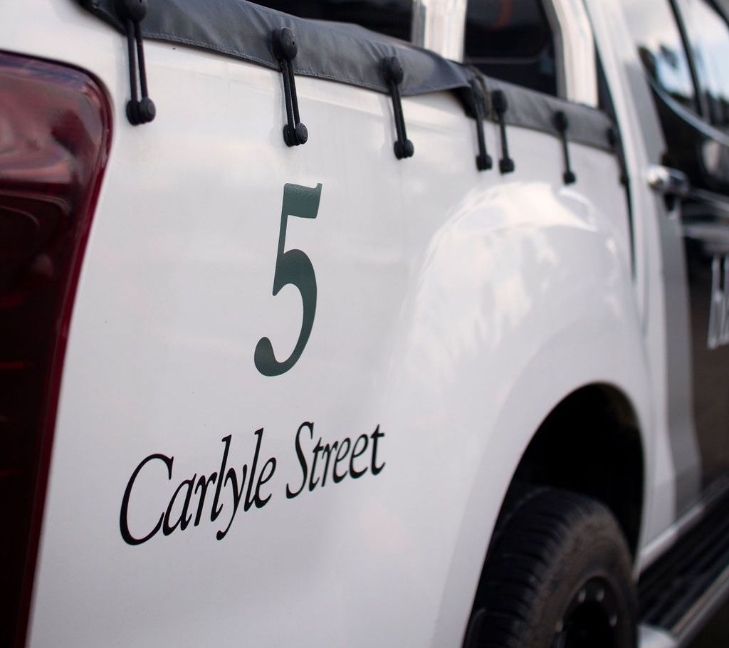 A Black & white accounting car with the number 5 Carlyle Street on it